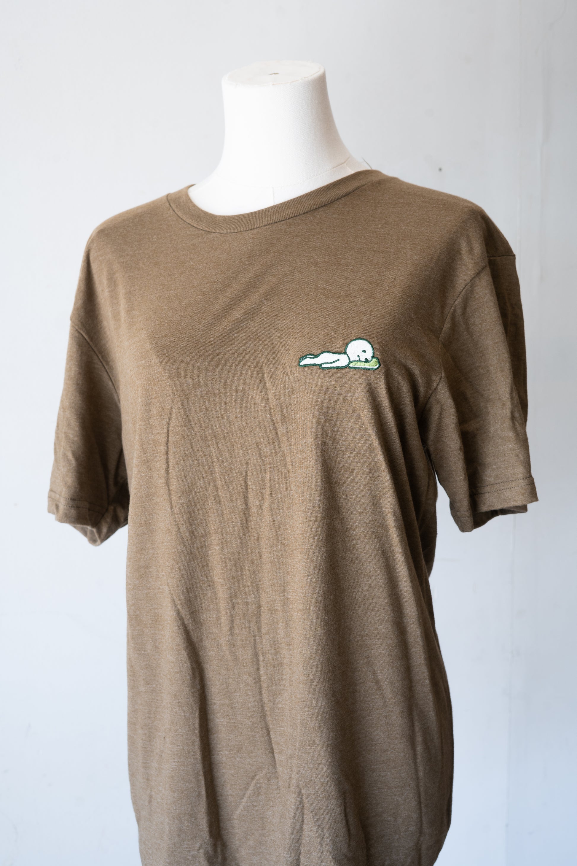 Laying Down Smiski T-Shirt (Brown/Green) - FlippedDimension