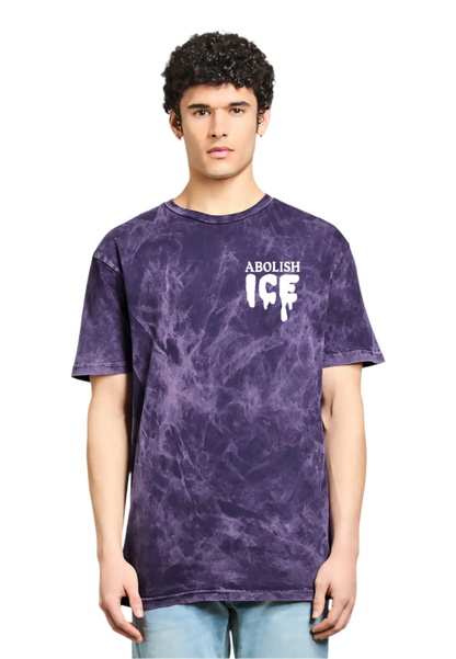 Person wearing a purple tie-dye t-shirt with 'Abolish ICE' text on a white background