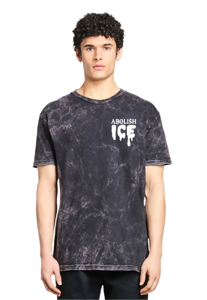 Person wearing a black tie-dye t-shirt with 'ABOLISH ICE' text on a white background
